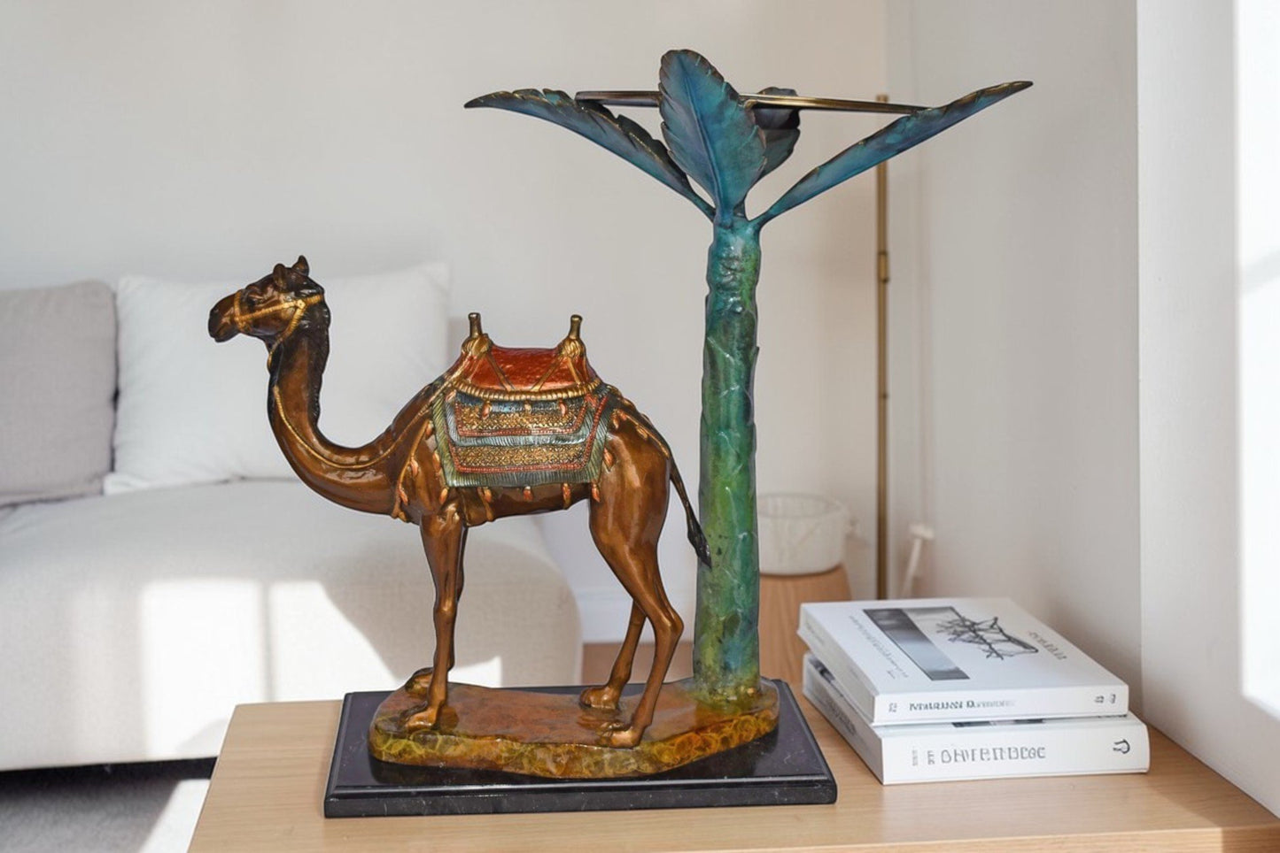 Camel Standing Under A Palm Tree Bronze Statue - Size: 20"L x 29"W x 25"H.
