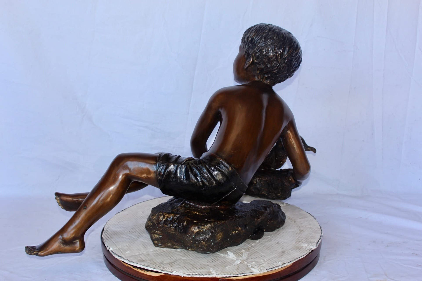 Adventurous boy with squirrel bronze statue -  Size: 36"L x 18"W x 22"H.