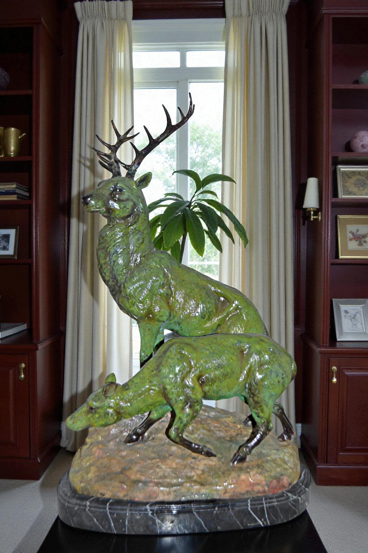 Two Deers Bronze Statue with a Green patina finish - Size: 15"L x 22"W x 32"H.