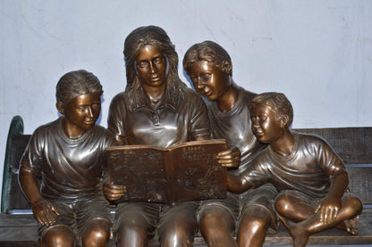 Mom and boys reading stories on bench bronze statue - Size: 53"L x 33"W x 39"H.