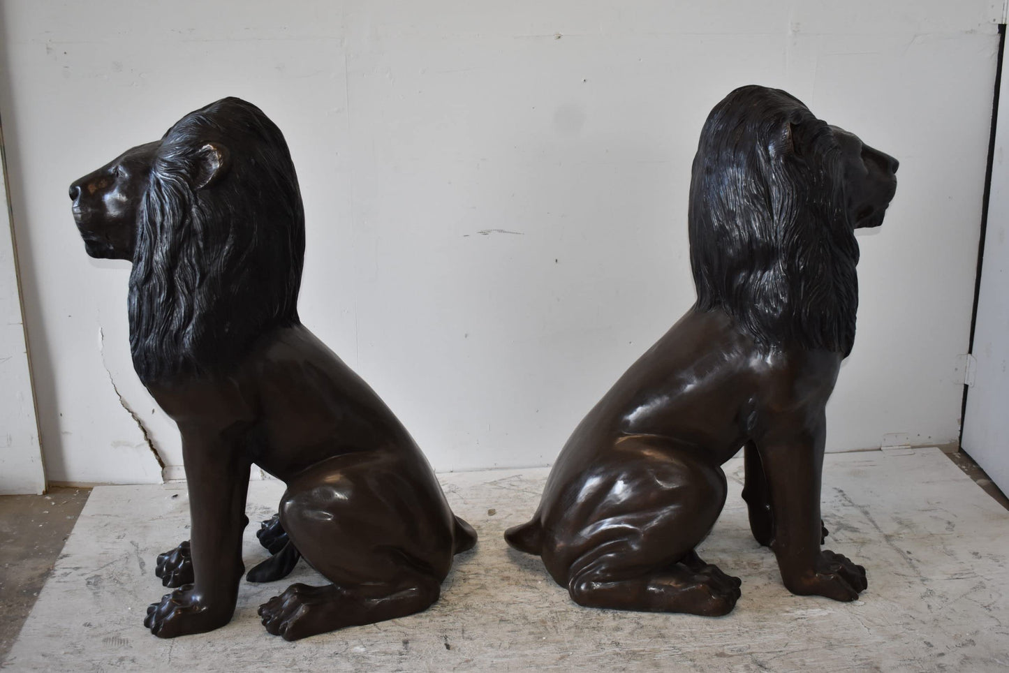 A Pair of Large Lions Sitting Side by Side Bronze Statues Size: 23" x 33" x 46"H