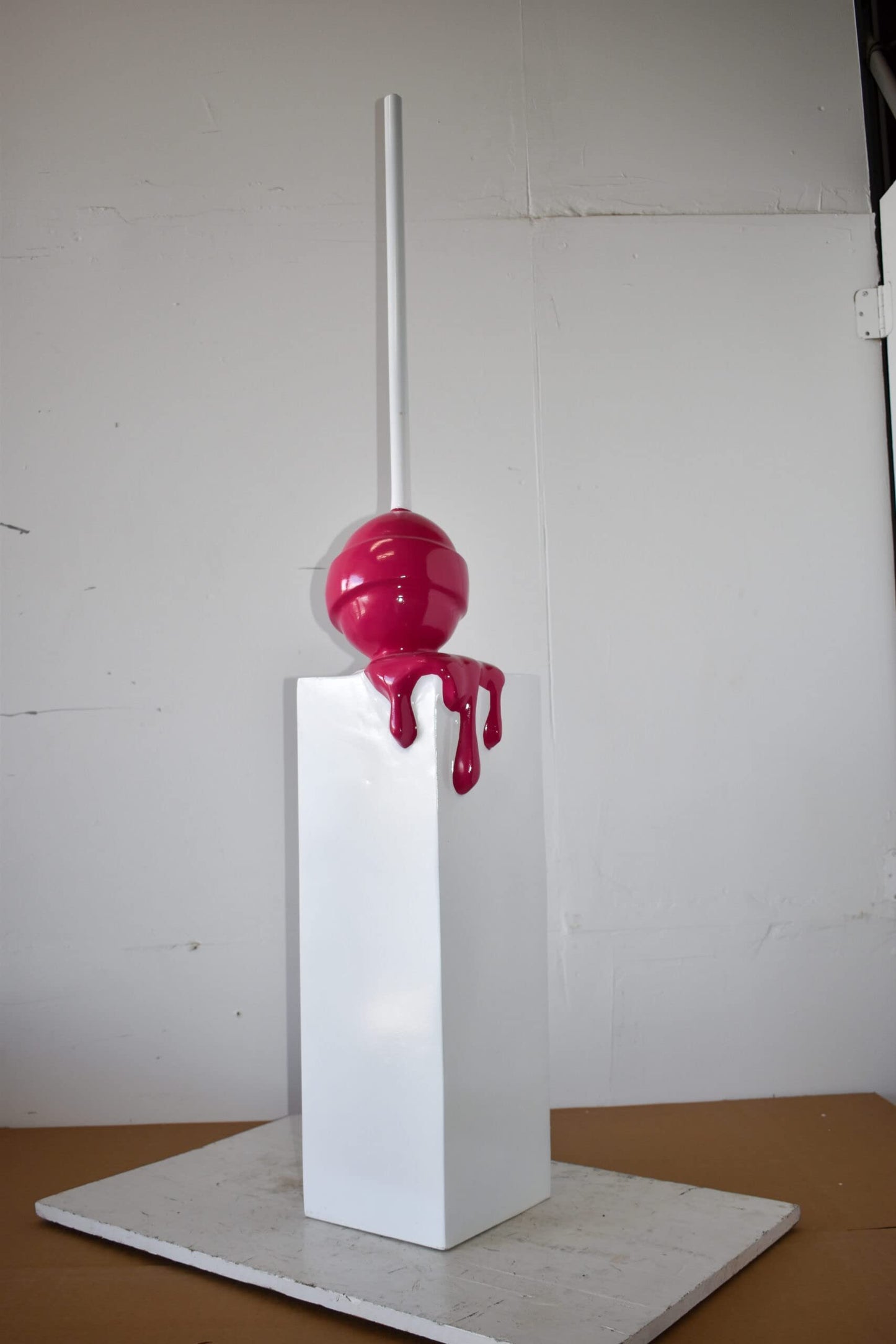 Red Lollipop Mounted on A White Pedestal Resin Statue Size: 10" x 10" x 59"H