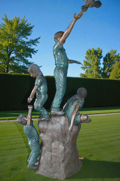 Four Kids Playing on a Rock Bronze Statue -  Size: 49"L x 26"W x 89"H.