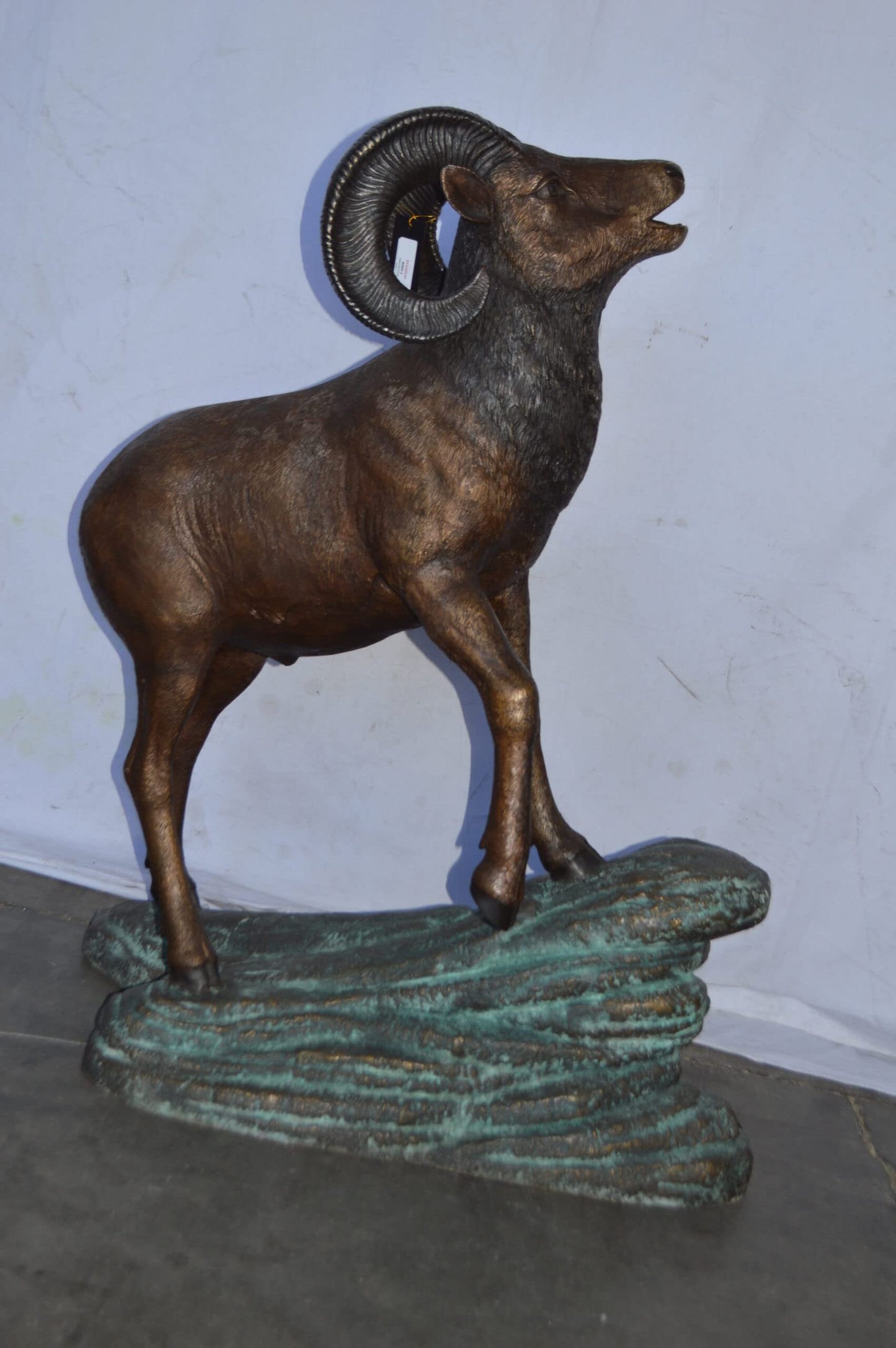 Life Size Ram standing on a rock Bronze Statue - Size: 38"L x 19"W x 45"H.