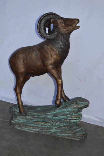 Life Size Ram standing on a rock Bronze Statue - Size: 38"L x 19"W x 45"H.