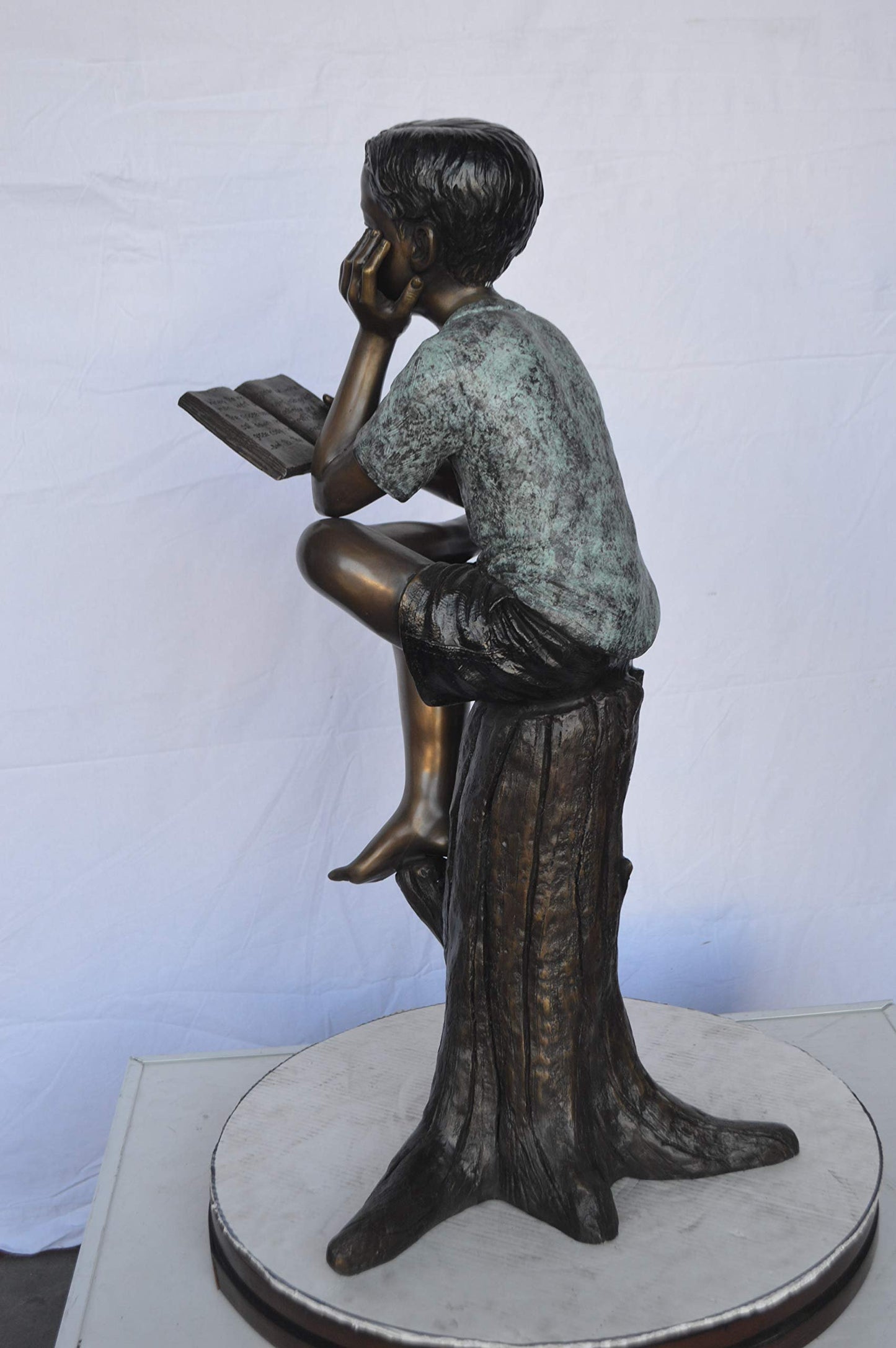Boy Sitting on a Stump Reading a Book -  Size: 18"L x 20"W x 35"H.