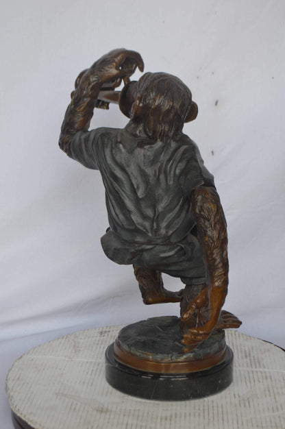 Monkey With Trumpet Bronze Statue - Size: 24"L x 12"W x 26"H.