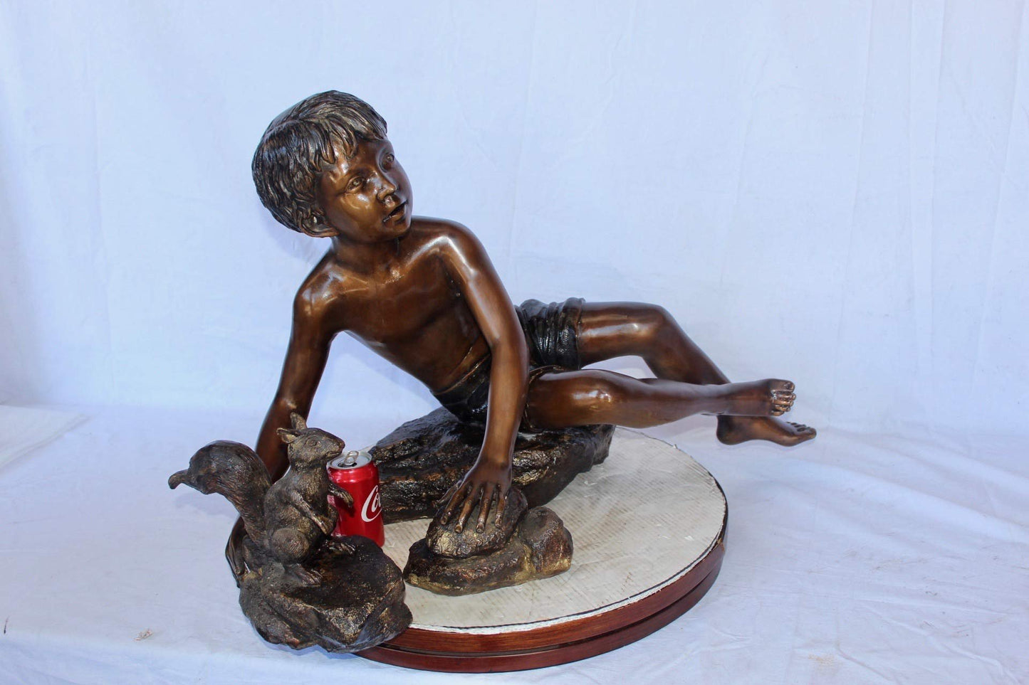Adventurous boy with squirrel bronze statue -  Size: 36"L x 18"W x 22"H.