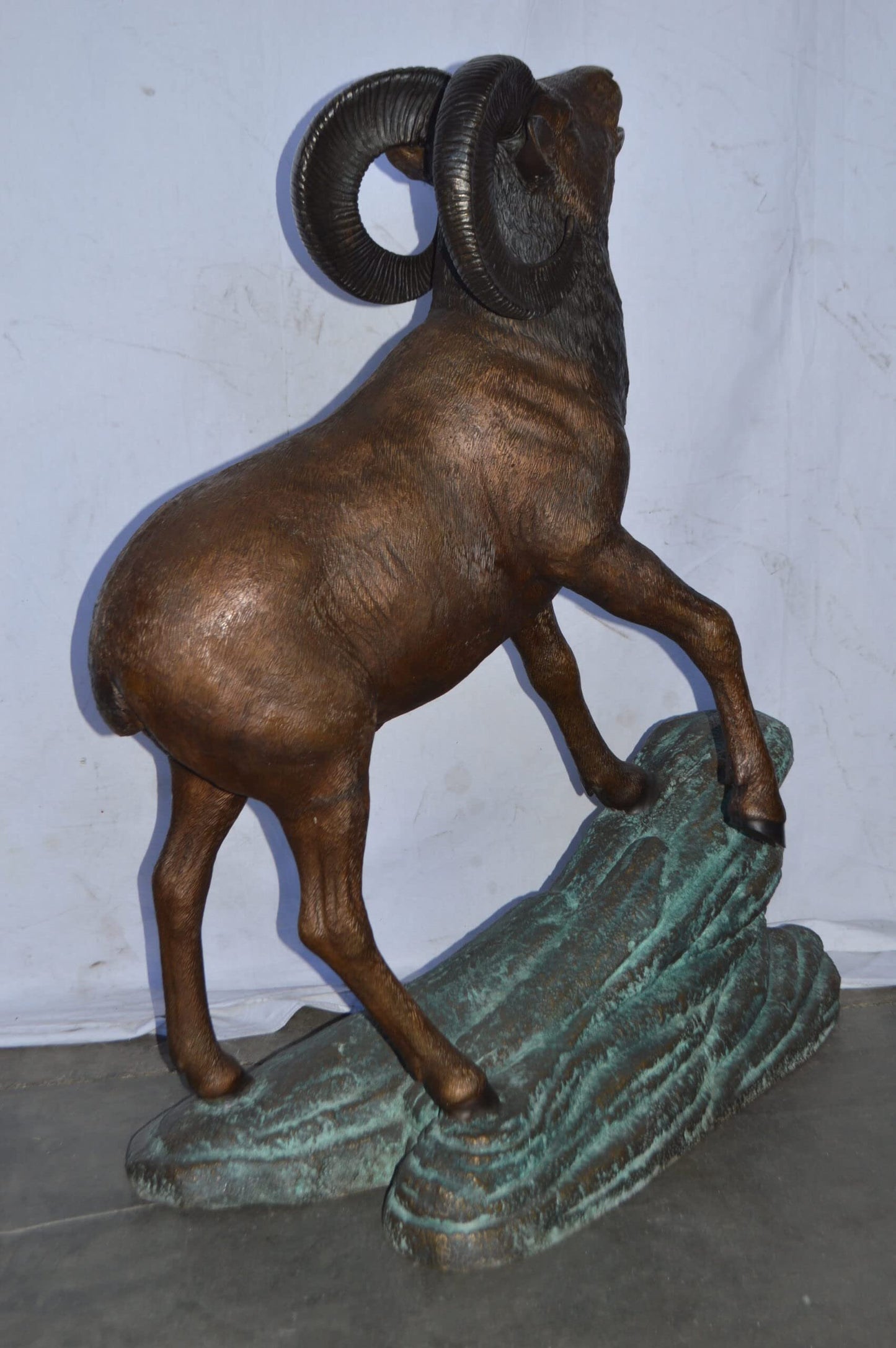Life Size Ram standing on a rock Bronze Statue - Size: 38"L x 19"W x 45"H.