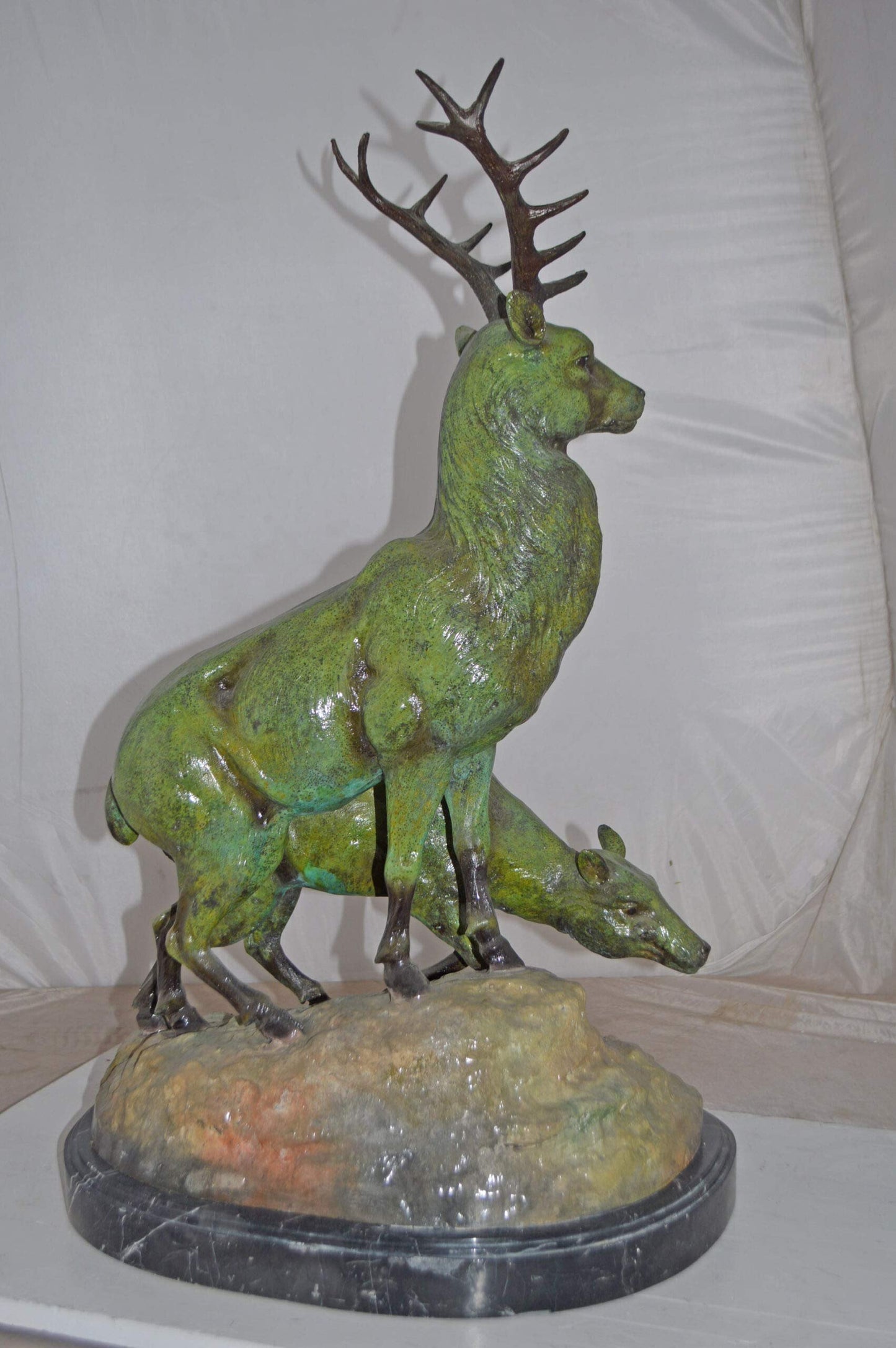 Two Deers Bronze Statue with a Green patina finish - Size: 15"L x 22"W x 32"H.