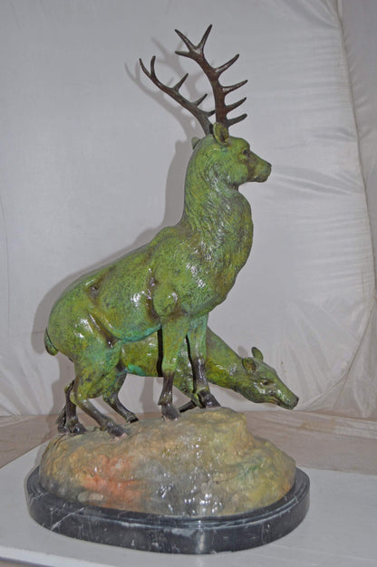 Two Deers Bronze Statue with a Green patina finish - Size: 15"L x 22"W x 32"H.