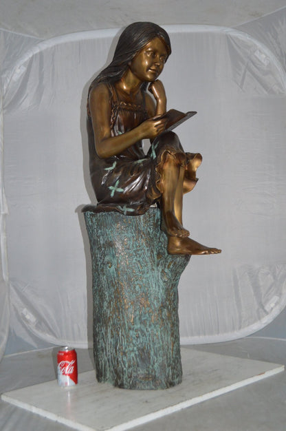 Sitting Girl on Log Reading a Book Bronze Statue -  Size: 19"L x 13"W x 48"H.