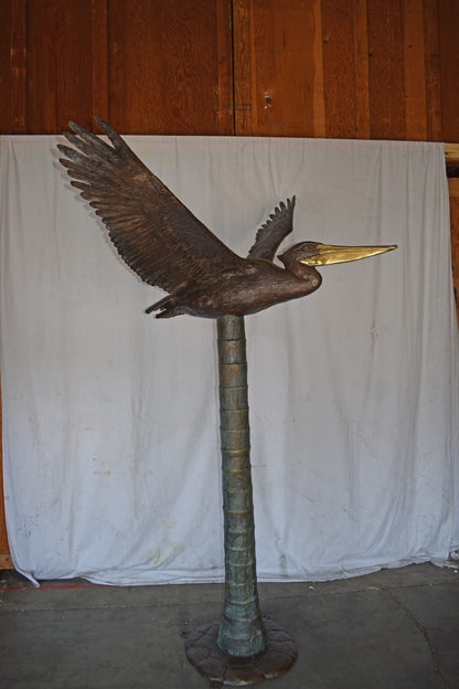 Life Size Pelican on a Three Bronze Statue - Size: 55"L x 46"W x 60"H.