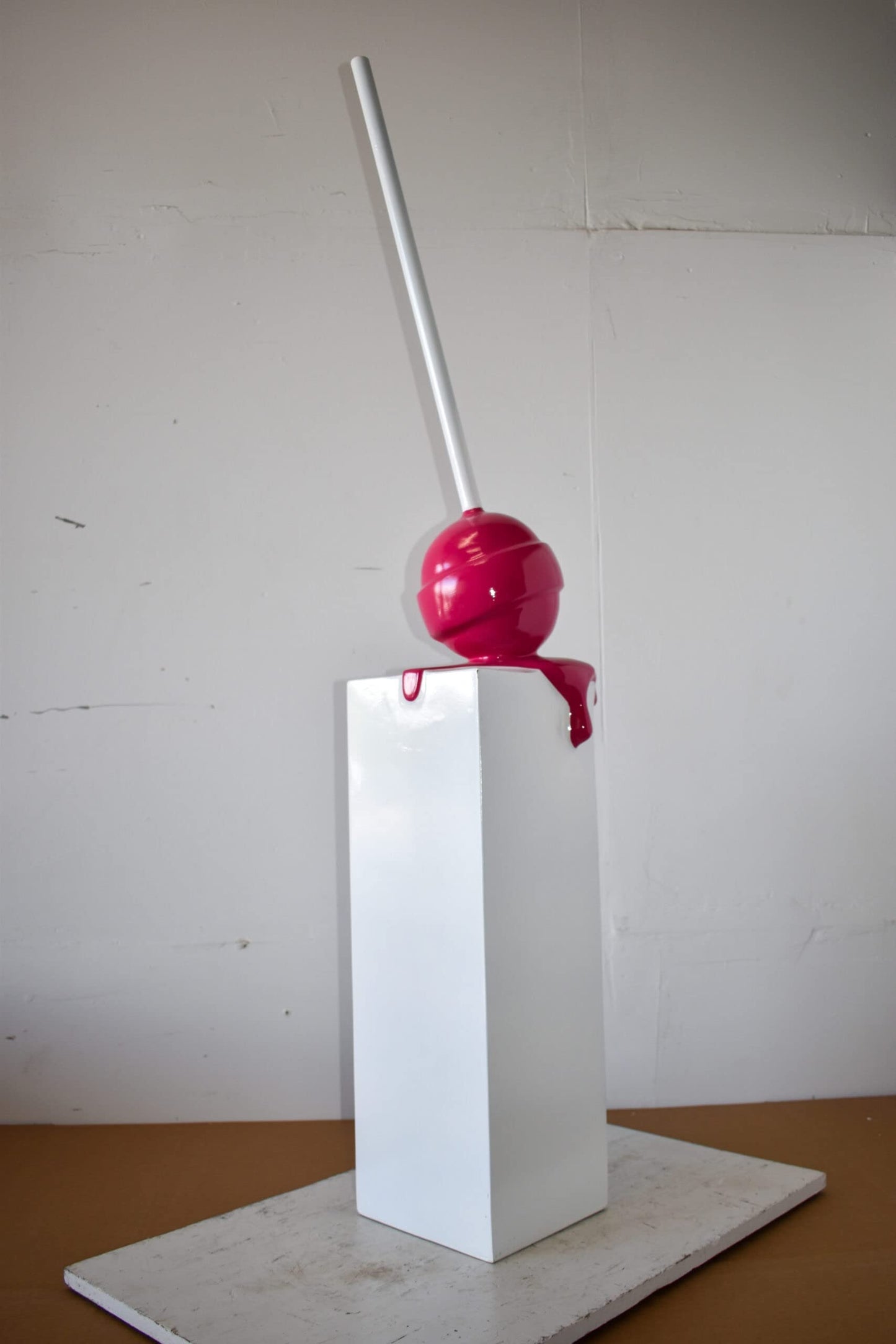 Red Lollipop Mounted on A White Pedestal Resin Statue Size: 10" x 10" x 59"H