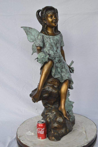 Angel girl sitting with a rose bronze statue -  Size: 22"L x 27"W x 37"H.