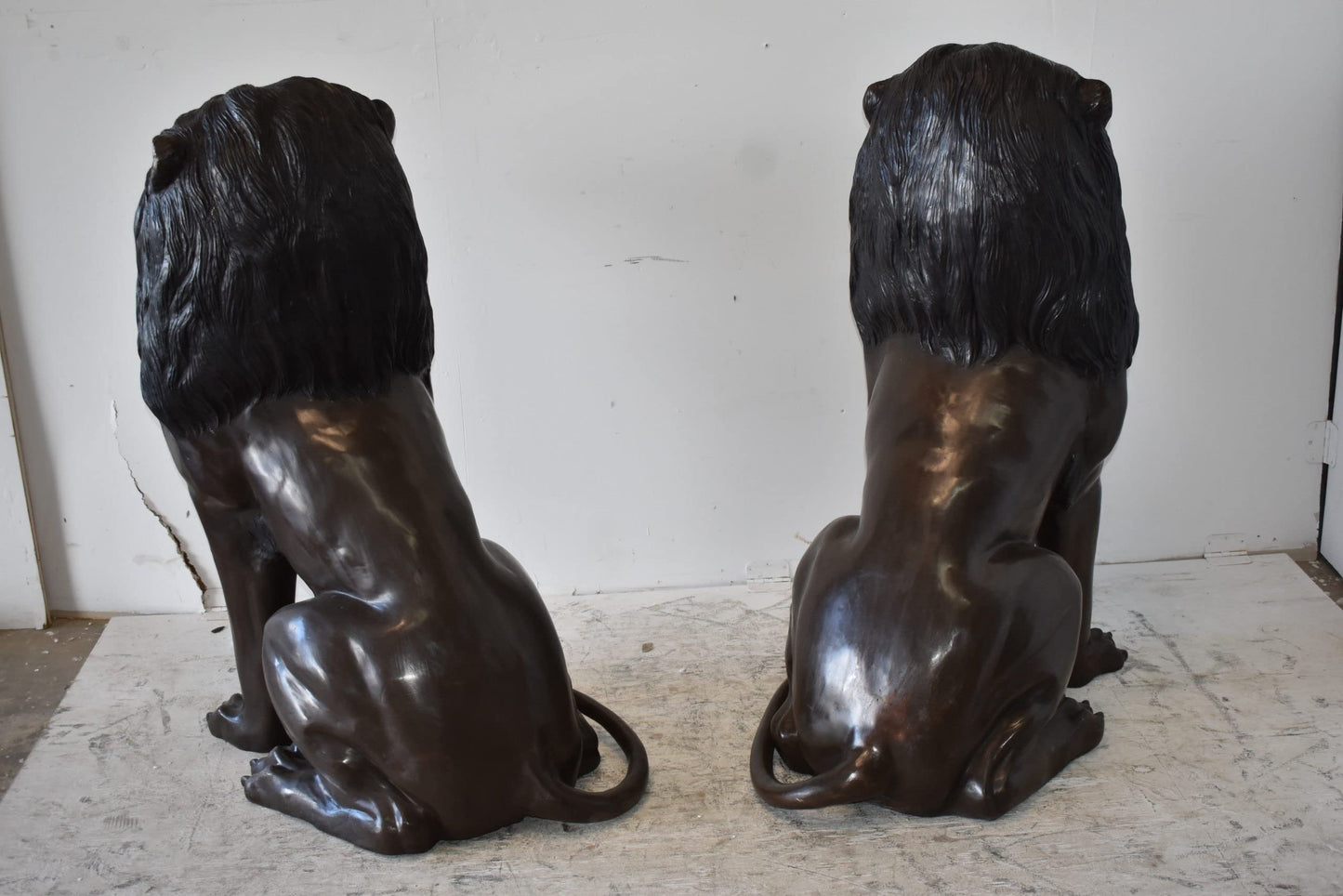 A Pair of Large Lions Sitting Side by Side Bronze Statues Size: 23" x 33" x 46"H