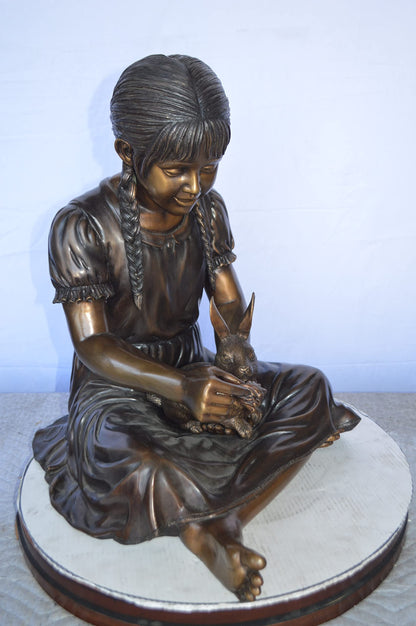 Sandra Sitting With Her Rabbit Bronze Statue -  Size: 25"L x 18"W x 25"H.