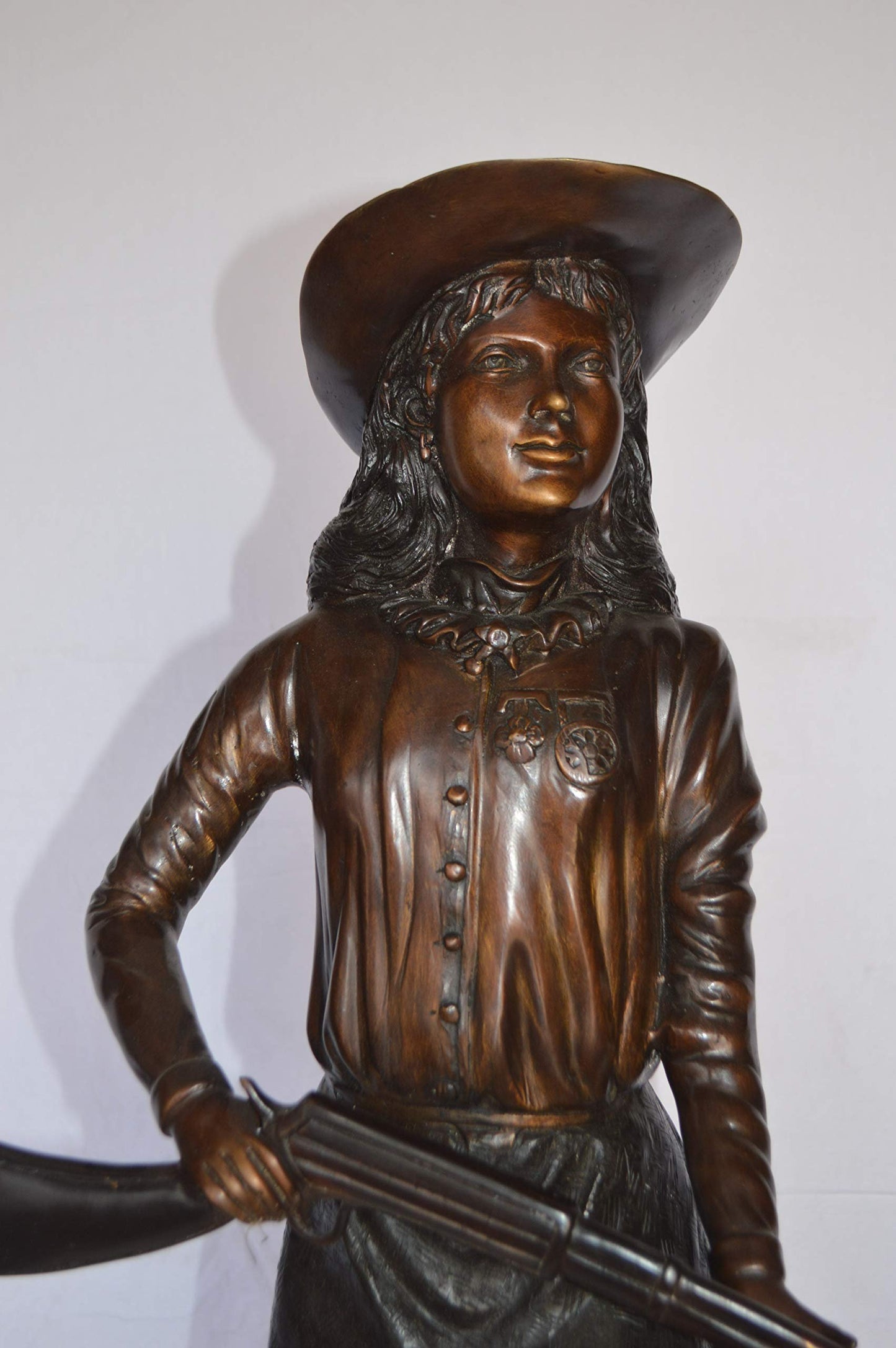 Annie Oakley Bronze Statue Mounted on a Marble Base -  Size: 11"L x 9"W x 33"H.