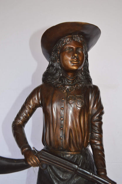 Annie Oakley Bronze Statue Mounted on a Marble Base -  Size: 11"L x 9"W x 33"H.