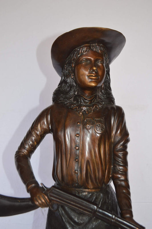 Annie Oakley Bronze Statue Mounted on a Marble Base -  Size: 11"L x 9"W x 33"H.