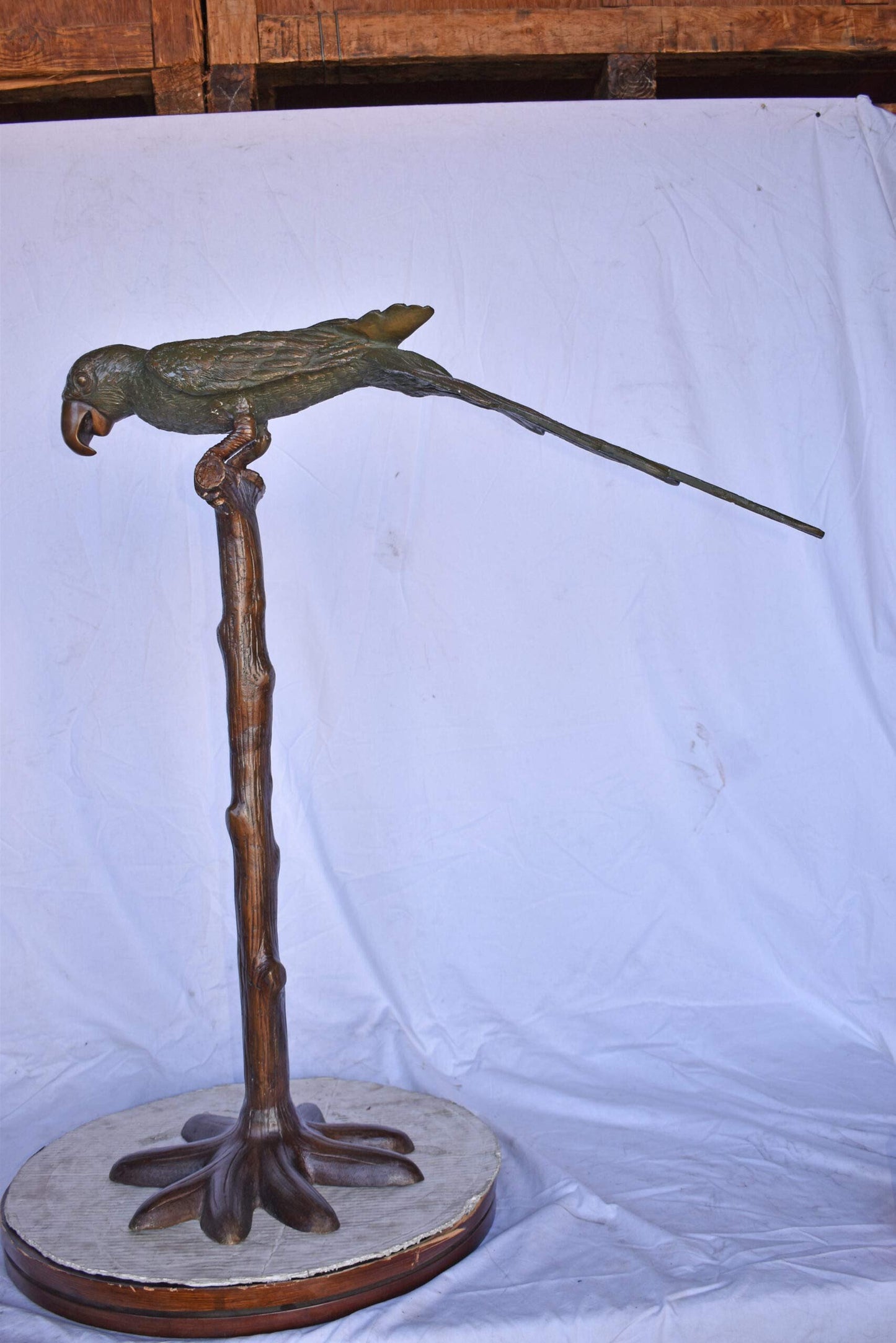 Parrot on a Tree Watching Forward Bronze Statue - Size: 36"L x 15"W x 41"H.