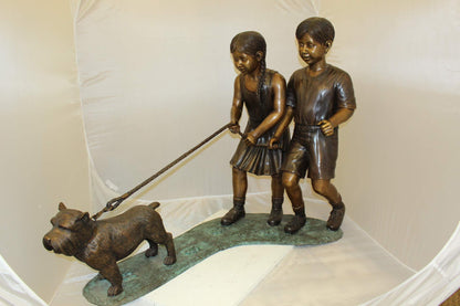 Two Kids Walking a dog Bronze Statue -  Size: 55"L x 28"W x 37"H.