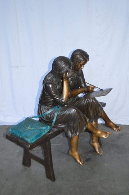 Two Schoolgirls Sitting On a Bench Bronze Statue -  Size: 45"L x 24"W x 41"H.