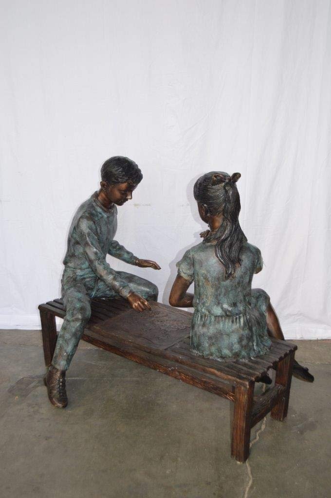 Young Couple Reviewing a World Map Bronze Statue -  Size: 32"L x 47"W x 42"H.