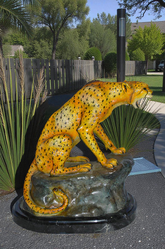 Cheetah sitting on a rock growling bronze statue - Size: 18"L x 12"W x 18"H.
