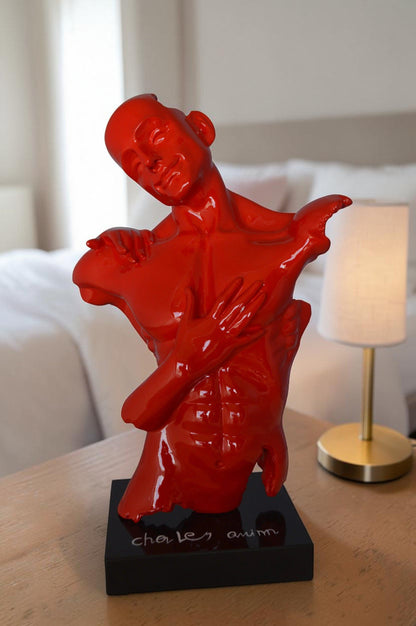 Modern resin statue of a man hugged by a woman -  Size: 17"L x 8"W x 24"H.