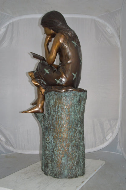 Sitting Girl on Log Reading a Book Bronze Statue -  Size: 19"L x 13"W x 48"H.