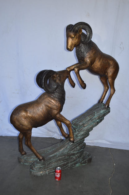 Two Life Size Rams on a rock Bronze Statue - Size: 49"L x 20"W x 64"H.