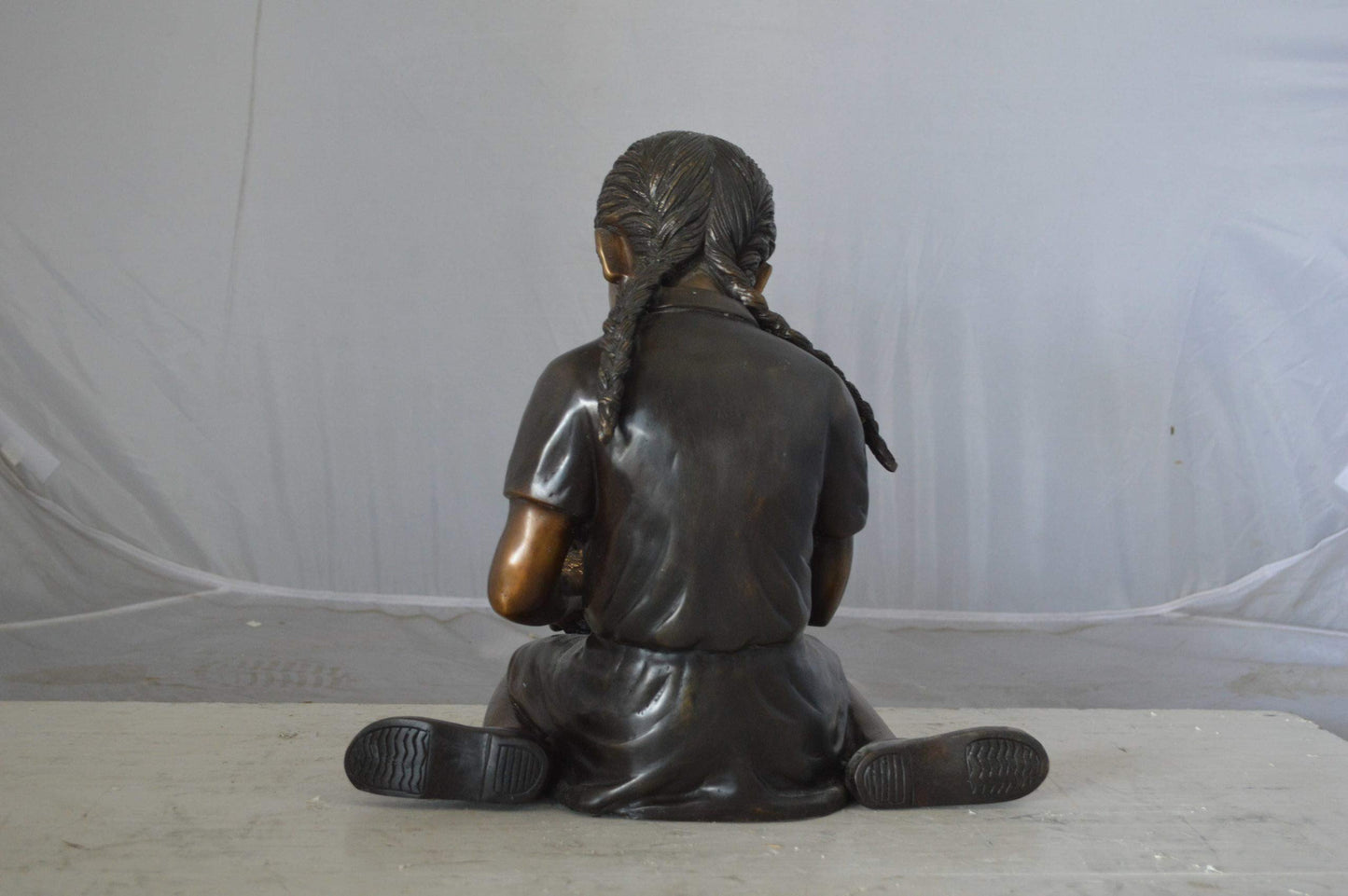 Young seated girl with bird bronze statue - Size: 12"L x 9"W x 14"H.