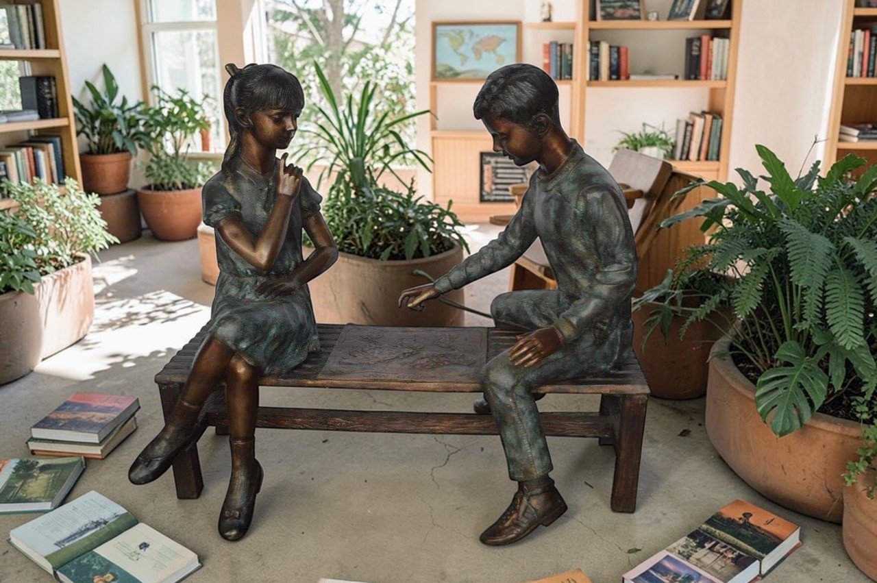 Young Couple Reviewing a World Map Bronze Statue -  Size: 32"L x 47"W x 42"H.