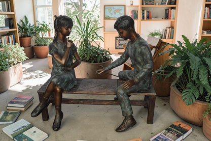 Young Couple Reviewing a World Map Bronze Statue -  Size: 32"L x 47"W x 42"H.
