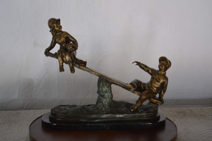 Boys Playing Seesaw on a Marble Base Bronze Statue -  Size: 22"L x 8"W x 17"H.