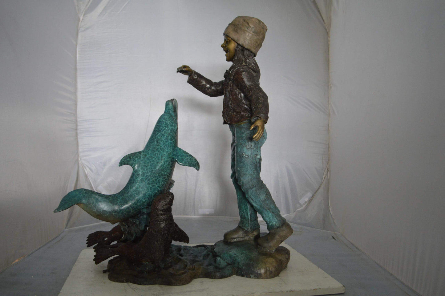 Girl feeding a dolphin and seals bronze fountain -  Size: 28"L x 17"W x 37"H.