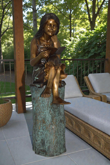 Sitting Girl on Log Reading a Book Bronze Statue -  Size: 19"L x 13"W x 48"H.