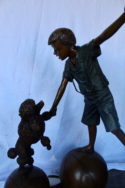 Boy and poodle balancing circus stars bronze statue -  Size: 38" x 27" x 55"H.