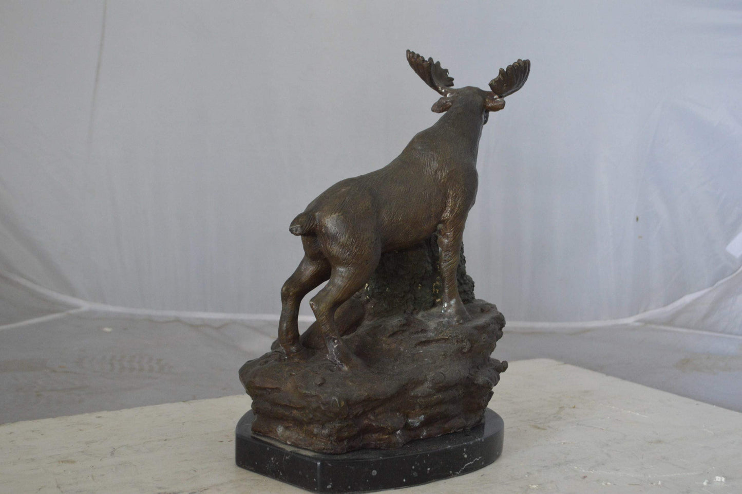 Moose on a rock bronze statue - Size: 9"L x 7"W x 14"H.
