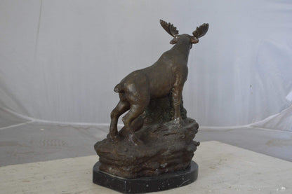 Moose on a rock bronze statue - Size: 9"L x 7"W x 14"H.