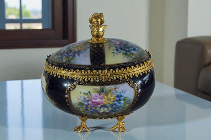 NIFAO Porcelain floral egg shaped lidded box with cherub and chicken feet 11"x8"x12"H