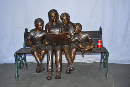Mom and boys reading stories on bench bronze statue - Size: 53"L x 33"W x 39"H.