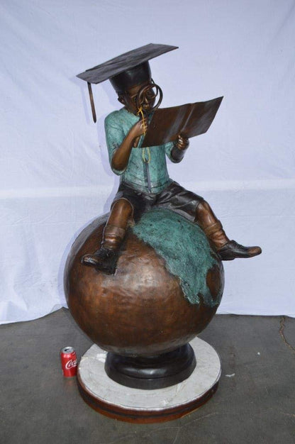 Student learning on top of world bronze statue -  Size: 28"L x 24"W x 52"H.