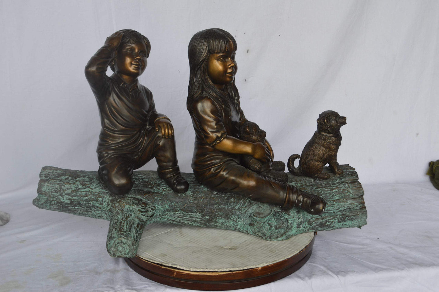 Young children and dog on a log bronze statue - Size: 40"L x 16"W x 24"H.