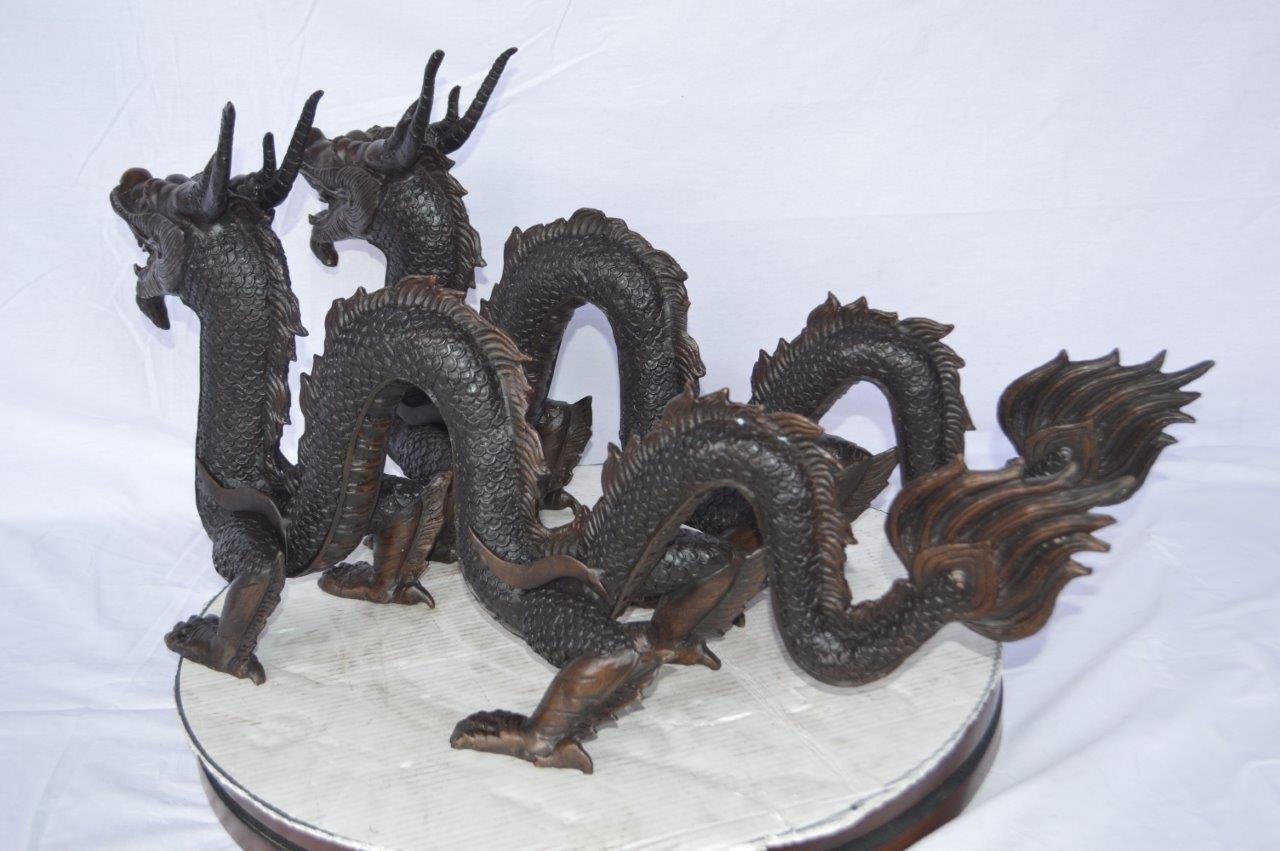 Pair of Dragons sitting side by side bronze statues -  Size: 31"L x 7"W x 16"H.