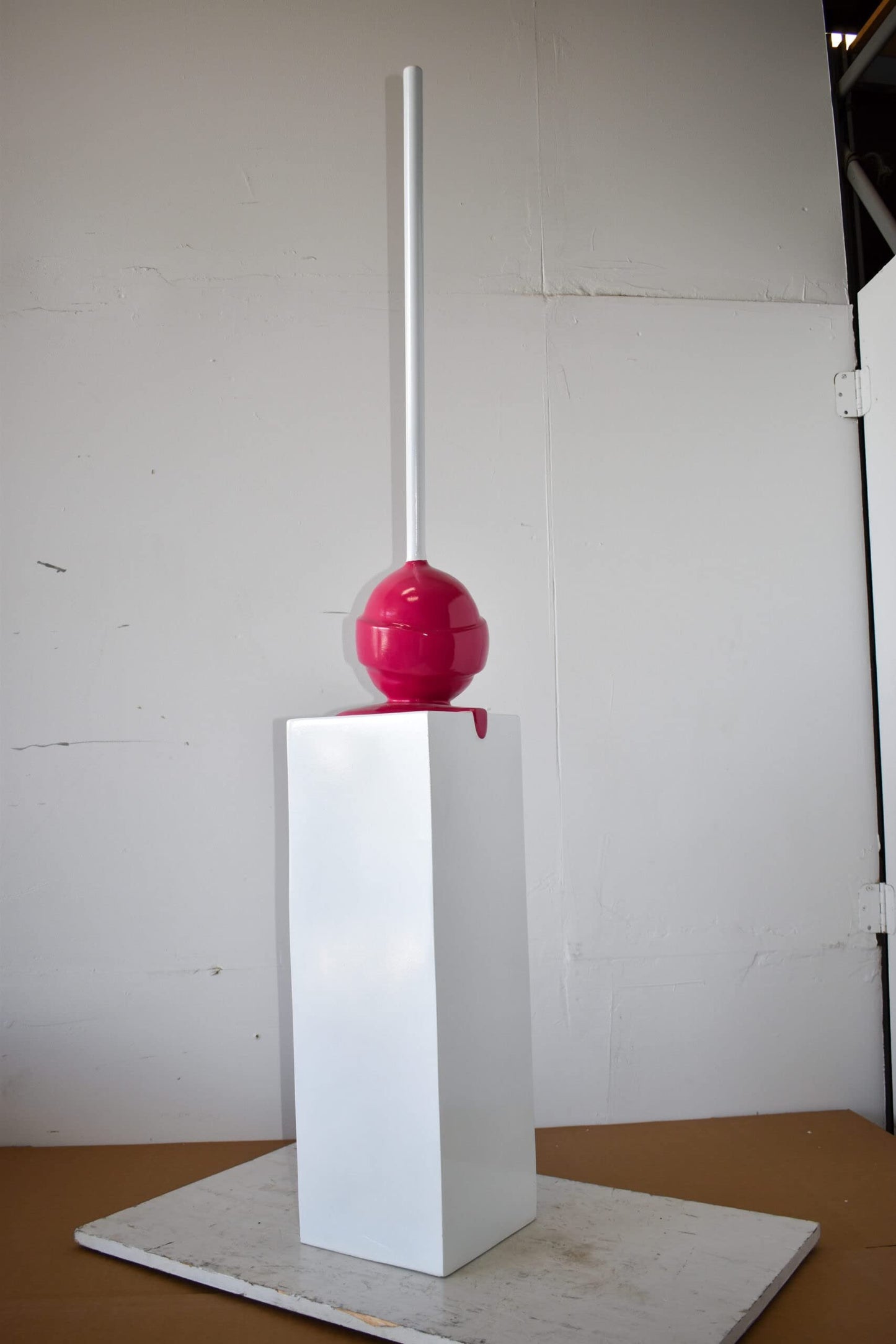 Red Lollipop Mounted on A White Pedestal Resin Statue Size: 10" x 10" x 59"H