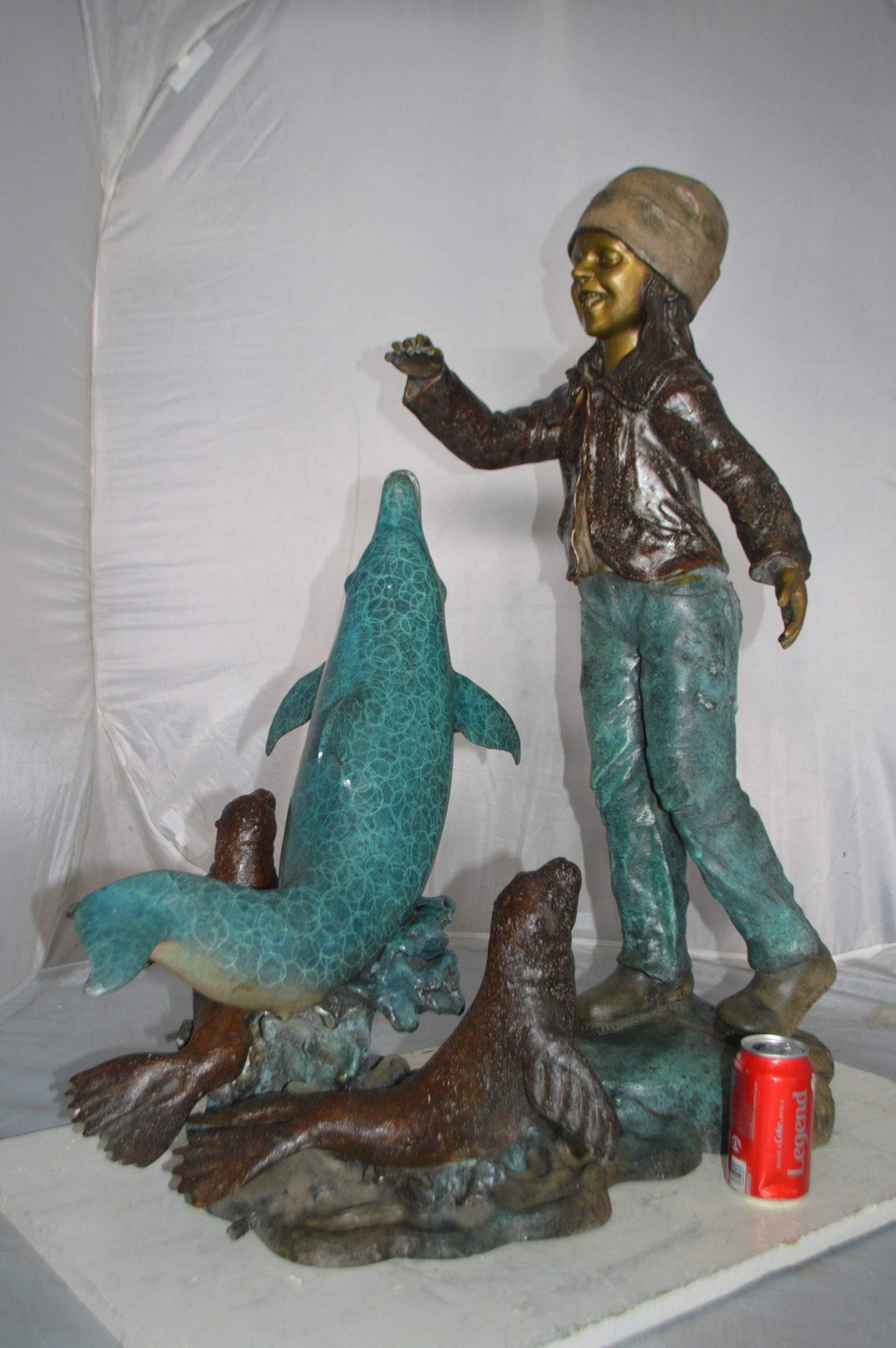 Girl feeding a dolphin and seals bronze fountain -  Size: 28"L x 17"W x 37"H.