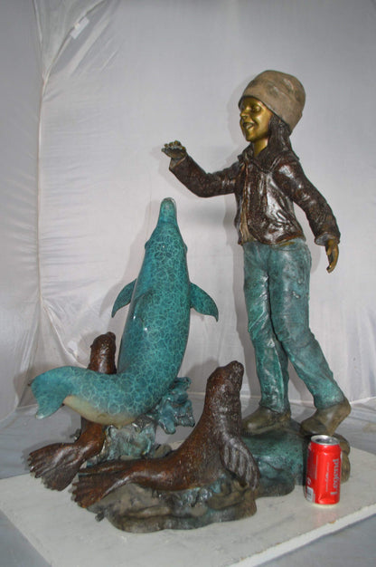 Girl feeding a dolphin and seals bronze fountain -  Size: 28"L x 17"W x 37"H.