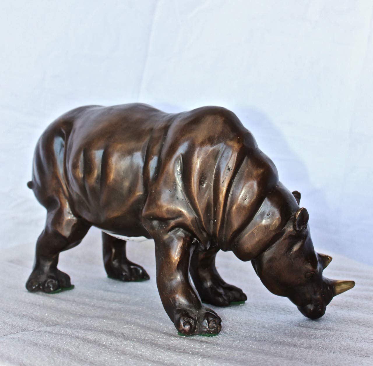 Relaxed Rhino bronze statue -  Size: 16"L x 9"W x 8"H.
